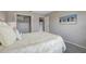 Bedroom features closet, bright window, calming colors, and neutral-toned wood-look flooring at 1400 Gandy N Blvd # 1701, St Petersburg, FL 33702