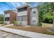 Two-story condo featuring gray siding, brick accents, screened balconies and a neatly maintained lawn at 1400 Gandy N Blvd # 1701, St Petersburg, FL 33702