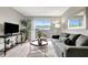 Living room featuring sliding glass doors to balcony, gray sofa and chair, wood-look flooring at 1400 Gandy N Blvd # 1701, St Petersburg, FL 33702