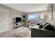 Living room featuring door, sliding glass doors to balcony, gray sofa and chair, wood-look flooring at 1400 Gandy N Blvd # 1701, St Petersburg, FL 33702
