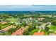 Aerial view of a community with a golf course, tennis courts, and a swimming pool at 14174 Thoroughbred Dr, Dade City, FL 33525