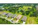 Scenic aerial view showcasing a neighborhood with beautiful homes, green spaces, and community amenities at 14174 Thoroughbred Dr, Dade City, FL 33525