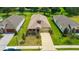 Beautiful aerial view of the home with a well-manicured lawn, long driveway and charming curb appeal at 14174 Thoroughbred Dr, Dade City, FL 33525