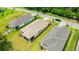 An aerial view shows a single-Gathering home with a screen patio, lawn and beautiful curb appeal at 14174 Thoroughbred Dr, Dade City, FL 33525