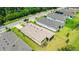 An aerial view of a single-Gathering home featuring a screened in patio and well-maintained lawn at 14174 Thoroughbred Dr, Dade City, FL 33525