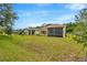 Enjoy a spacious backyard with a screened-in lanai, lush lawn and the option for outdoor relaxation at 14174 Thoroughbred Dr, Dade City, FL 33525
