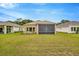Expansive backyard featuring a screened-in lanai, perfect for outdoor living and entertaining at 14174 Thoroughbred Dr, Dade City, FL 33525