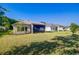 The house with a lawn is surrounded by trees at 14174 Thoroughbred Dr, Dade City, FL 33525