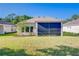 A backyard featuring a screened lanai for outdoor living and entertaining at 14174 Thoroughbred Dr, Dade City, FL 33525
