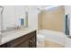 Bathroom featuring a marble countertop, modern fixtures, and a tiled shower and tub at 14174 Thoroughbred Dr, Dade City, FL 33525