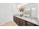 Bathroom features granite countertops, a large mirror, and dark cabinets at 14174 Thoroughbred Dr, Dade City, FL 33525