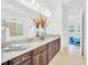 Bathroom features granite countertops, a large mirror and dark cabinets at 14174 Thoroughbred Dr, Dade City, FL 33525
