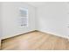 Bright bedroom featuring a light wood floor and a window providing natural light at 14174 Thoroughbred Dr, Dade City, FL 33525