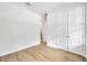 Bedroom with light wood floors, white walls, and double doors for closet space at 14174 Thoroughbred Dr, Dade City, FL 33525