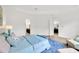 Bright bedroom with blue accents, white walls and plenty of natural light at 14174 Thoroughbred Dr, Dade City, FL 33525