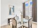 Dining room with curtains, modern lighting, and ample natural light at 14174 Thoroughbred Dr, Dade City, FL 33525