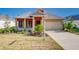Charming single-story home with a well-manicured lawn and attached two-car garage at 14174 Thoroughbred Dr, Dade City, FL 33525