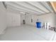 Spacious two-car garage with epoxy flooring and ample storage, with attached utility closet at 14174 Thoroughbred Dr, Dade City, FL 33525