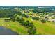 Overhead view of a meticulously landscaped golf course with ponds and surrounding luxury homes at 14174 Thoroughbred Dr, Dade City, FL 33525