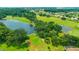 Beautiful golf course featuring lush greenery, mature trees and a scenic lake at 14174 Thoroughbred Dr, Dade City, FL 33525