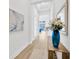 Bright hallway with beautiful flooring, neutral paint, and a view to the living room at 14174 Thoroughbred Dr, Dade City, FL 33525