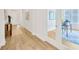 Hallway view leading to a home office with a desk and chair, and natural light at 14174 Thoroughbred Dr, Dade City, FL 33525