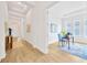 Hallway view leading to a bright home office with a desk, chair, and natural light at 14174 Thoroughbred Dr, Dade City, FL 33525