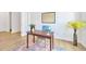 Bright home office featuring wood floors, a desk, and a globe at 14174 Thoroughbred Dr, Dade City, FL 33525