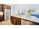 Kitchen island with stainless steel appliances and wooden cabinets at 14174 Thoroughbred Dr, Dade City, FL 33525