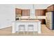 Open kitchen with island seating and stainless steel refrigerator at 14174 Thoroughbred Dr, Dade City, FL 33525