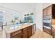 Kitchen island with sink and view of living room and dining area at 14174 Thoroughbred Dr, Dade City, FL 33525