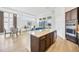 Modern kitchen featuring a large island, stainless steel appliances, and an open layout to the living and dining areas at 14174 Thoroughbred Dr, Dade City, FL 33525