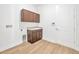 Laundry room with upper cabinets, a sink, and a white door at 14174 Thoroughbred Dr, Dade City, FL 33525