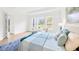 Bright main bedroom showcasing large windows, neutral tones, and comfortable seating for a tranquil atmosphere at 14174 Thoroughbred Dr, Dade City, FL 33525