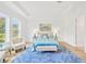 Serene main bedroom features large windows, plush carpeting, and a calming color palette for a relaxing retreat at 14174 Thoroughbred Dr, Dade City, FL 33525