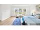 Bright main bedroom showcasing large windows, neutral tones, and comfortable seating for a tranquil atmosphere at 14174 Thoroughbred Dr, Dade City, FL 33525