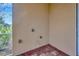 Corner view of an empty screened in patio featuring brick flooring and exterior wall at 14174 Thoroughbred Dr, Dade City, FL 33525
