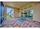 Covered patio featuring brick flooring, outdoor seating, and view through sliding glass doors at 14174 Thoroughbred Dr, Dade City, FL 33525