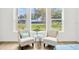 Cozy bedroom seating area features comfortable chairs, natural light, and serene views for relaxation and comfort at 14174 Thoroughbred Dr, Dade City, FL 33525