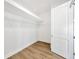 Well-organized walk-in closet features built-in shelving and laminate wood flooring at 14174 Thoroughbred Dr, Dade City, FL 33525