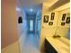 Bright bathroom featuring a large mirror, vanity, shower, and charming butterfly artwork at 14334 Teasdale Ave, Hudson, FL 34667