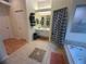 Bathroom with neutral tile flooring, white cabinets, towel rack, shower and a large soaking tub at 14334 Teasdale Ave, Hudson, FL 34667
