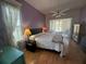 Bright bedroom with a large window and ceiling fan, ideal for relaxation and comfort at 14334 Teasdale Ave, Hudson, FL 34667
