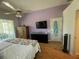 Comfortable bedroom with ceiling fan, television, and dresser, perfect for relaxation at 14334 Teasdale Ave, Hudson, FL 34667