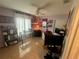 Well decorated bedroom with ceiling fan, tile floor, built in shelving, and a lot of Ohio State memorabilia at 14334 Teasdale Ave, Hudson, FL 34667