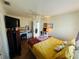 Bedroom features double closet doors, a ceiling fan, laminate flooring, a desk, and a TV at 14334 Teasdale Ave, Hudson, FL 34667