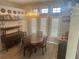 Charming dining area with decorative chandelier, classic furniture and lots of natural light at 14334 Teasdale Ave, Hudson, FL 34667