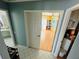 Hallway view leading to bedroom with white closet shelving and a bathroom with sink in the background at 14334 Teasdale Ave, Hudson, FL 34667