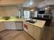 Bright kitchen with stainless steel sink and view into living room at 14334 Teasdale Ave, Hudson, FL 34667