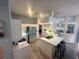 Modern kitchen with white cabinetry, an island with seating, and stainless steel appliances at 14334 Teasdale Ave, Hudson, FL 34667
